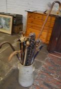 Stone ware churn containing shepherd's crook & various walking sticks