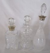 3 cut glass decanters, 2 with silver collars H 39 cm, 30 cm and 28 cm