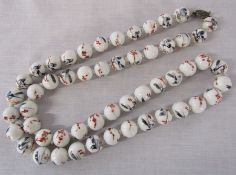 String of Chinese hand painted ceramics beads with silver clasp L 85 cm