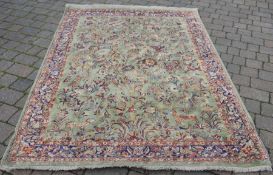 Green ground Middle Eastern carpet 240cm by 168cm