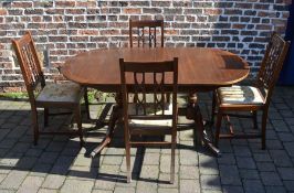 Extending dining table and four chairs