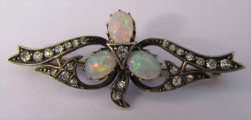 Tested as 18ct gold diamond and opal brooch weight 4.4 g L 45 mm (opal size 6 mm x 5 mm each)