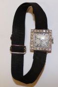 Art Deco platinum & diamond set cocktail watch on material strap - the square case with chased