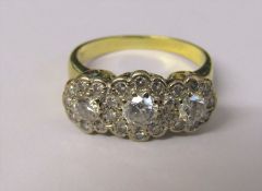 Tested as 18ct gold diamond trilogy ring, central diamond 0.33 ct, outer diamonds 0.15 ct and