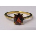 9ct gold red garnet ring with diamond accents to shoulders size U weight 2.9 g