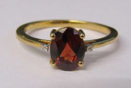 9ct gold red garnet ring with diamond accents to shoulders size U weight 2.9 g