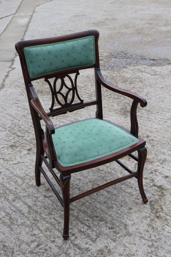 A lady's Edwardian walnut and line inlaid elbow chair with padded top rail and pierced splat