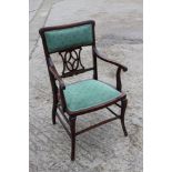 A lady's Edwardian walnut and line inlaid elbow chair with padded top rail and pierced splat