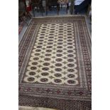 A Teke Bokhara rug with sixty-four guls on a cream ground and multi-bordered in traditional