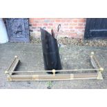 An Edwardian brass scroll end fender curb, a cast iron fire back with George and Dragon design, a