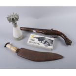 A kukri with bone handle, a replica flintlock pistol and a .22 calibre starter revolver, in original