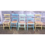 A set of five Victorian painted bedroom chairs with Gothic pierced bar backs and cane seats