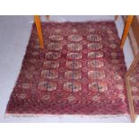 A Bokhara rug of traditional design with eighteen guls, 38 1/2" x 47" approx