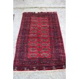 A Bokhara rug with numerous guls on a red ground and multi-bordered in traditional shades, 51" x 79"