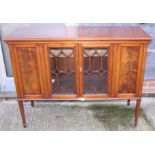 A mahogany side cabinet enclosed Gothic lattice glazed doors, on square taper supports, 50" wide