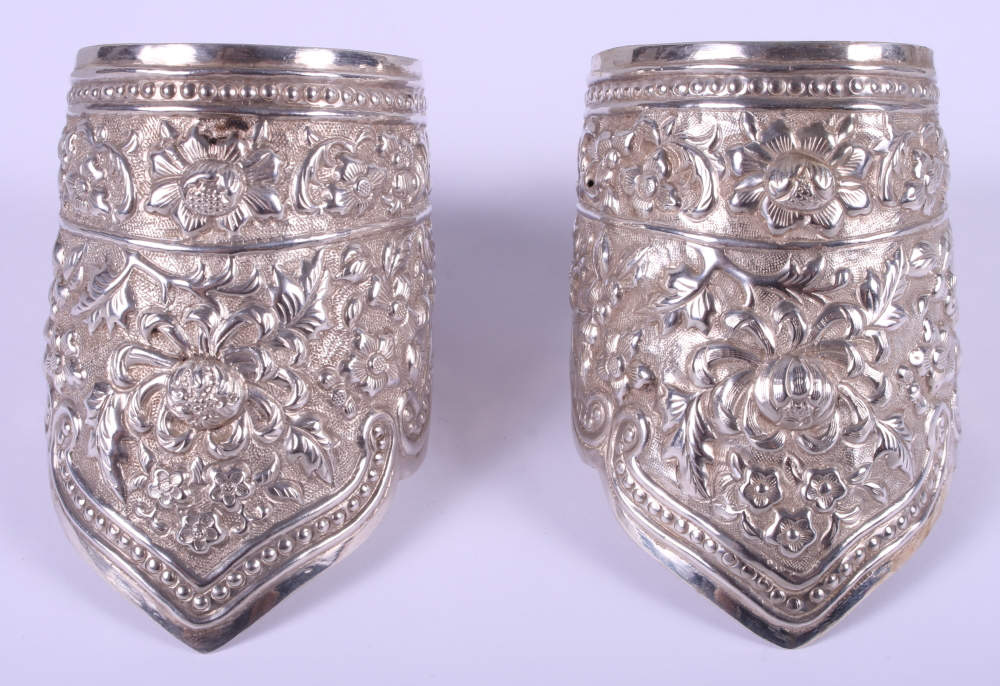 A pair of 19th century Chinese solid silver wedding cuffs / bangles with embossed floral decoration,