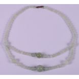 A mid 20th Chinese two-strand jade spherical bead necklace, 20" long