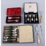 A cased set of silver teaspoons, a cased set of silver coffee spoons, a cased fork and pusher, a