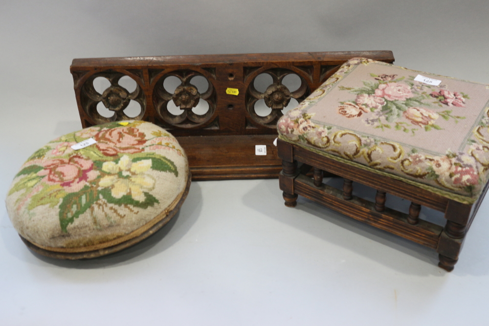 A Gothic design wall shelf, two embroidered footstools and an oval wall mirror, in painted and