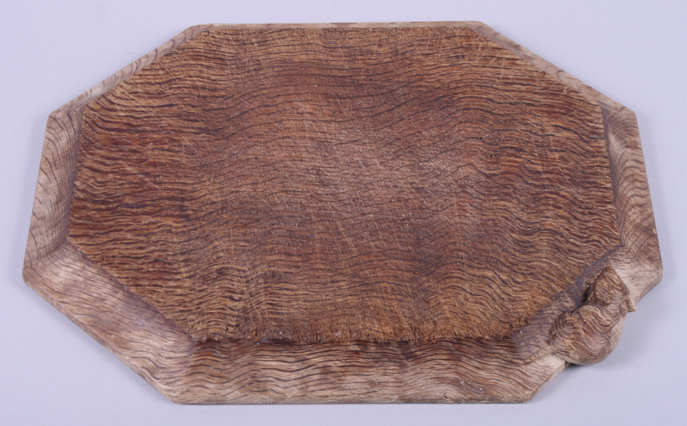 A Robert "Mouseman" Thompson carved oak elongated octagonal cheese board, 12" x 10"