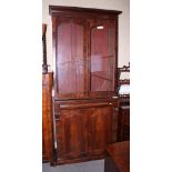A George IV mahogany bookcase, the upper section enclosed Gothic arch top glazed doors over