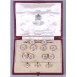 A yellow metal and mother-of-pearl cufflink and stud set, in tooled and gilt morocco leather case,