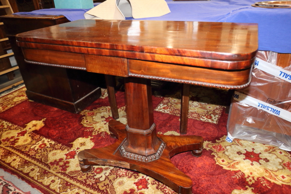 An early Victorian mahogany fold-over top card table, on faceted column and quadraform base, 36"