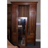 An Edwardian and walnut wardrobe, fitted one drawer and enclosed mirror panel door, by Whiteley,