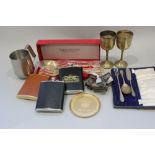 Three hip flasks, a pair of bronze salad servers, six silver plated napkin rings and various other