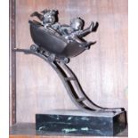 A bronzed figure of two children in a rollercoaster cart, on marble base