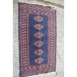 A modern Bokhara rug on a blue ground, 36" x 65" approx