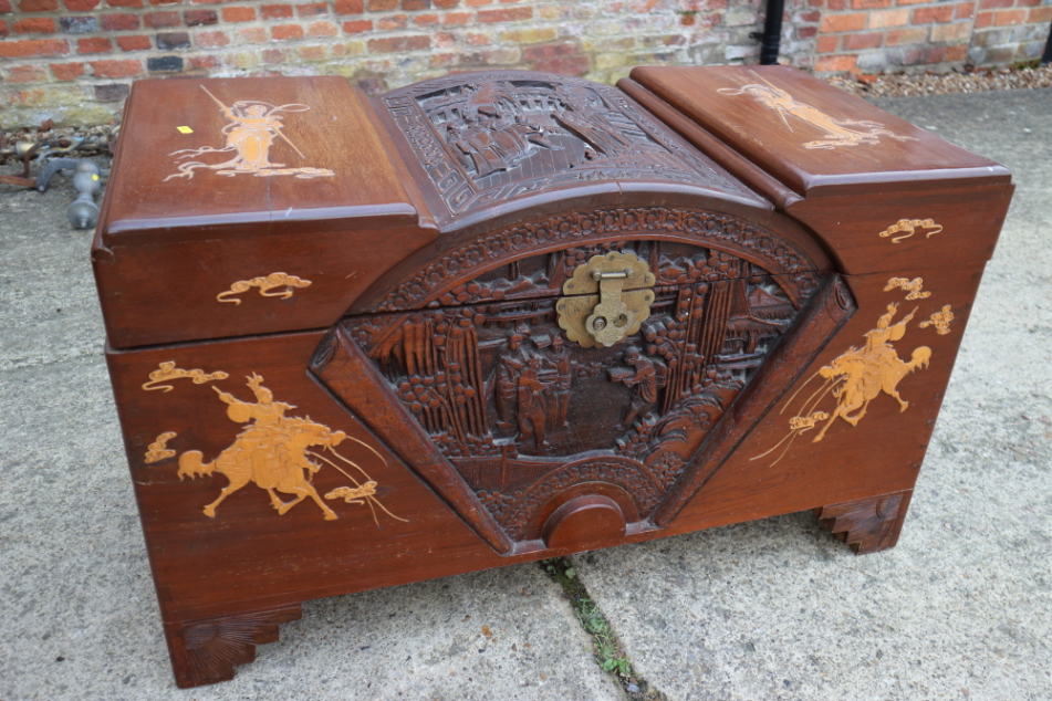 A Chinese carved camphor wood blanket box with figure decoration, 40" wide