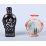 A Chinese black papier-mache snuff bottle and stopper with applied mother-of-pearl flower