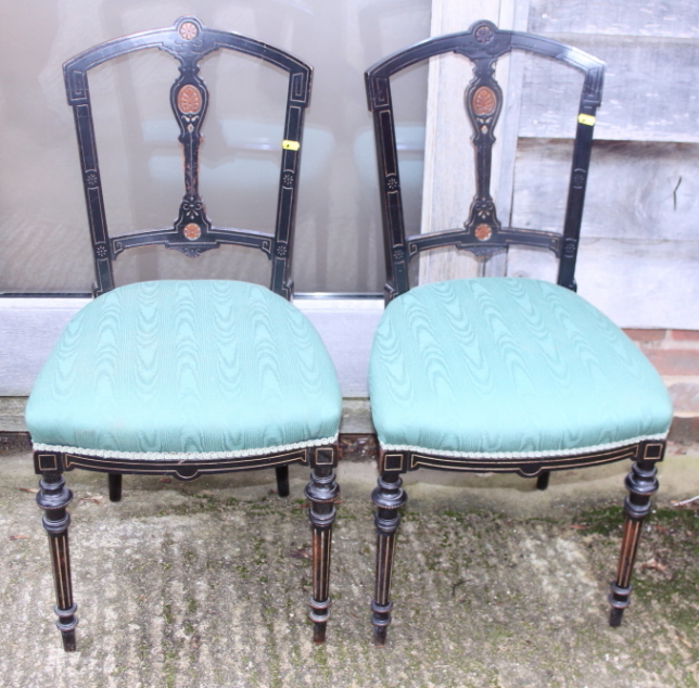A pair of late Victorian ebonised Gillows chairs, on fluted supports