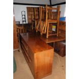 A 1950s walnut dining suite, comprising a refectory style table, 20" x 72", six lath back chairs