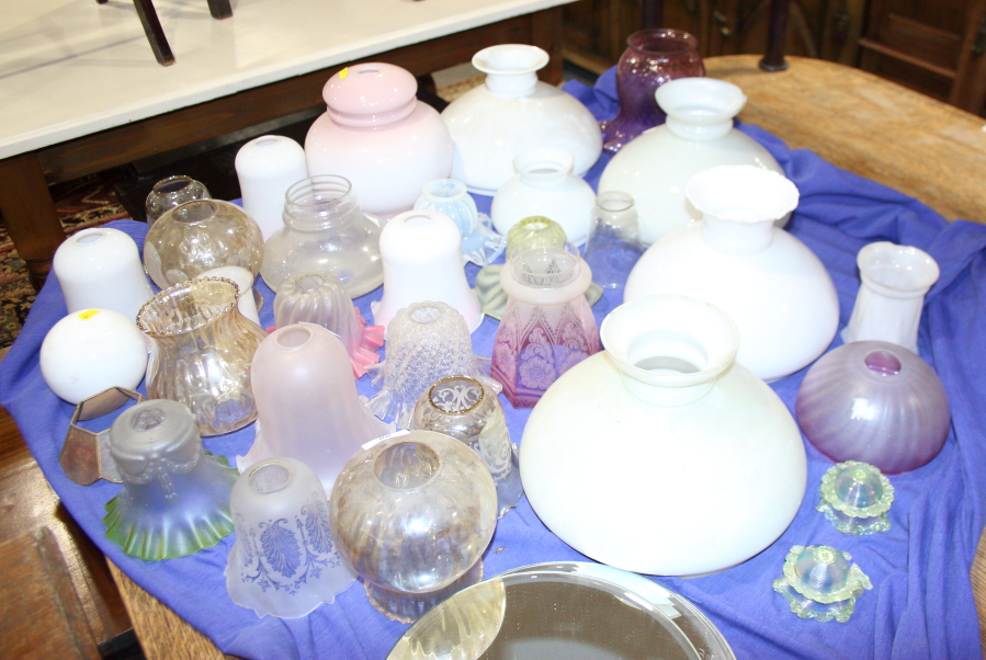 A collection of lustre, coloured, vaseline and other glass oil lamp and light shades