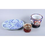 A Japanese peony decorated oval dish, an Imari cache pot, a satsuma bowl and two Japanese lacquer