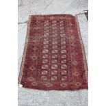 A Bokhara rug with thirty-nine guls in traditional shades, 47" x 67" approx (worn)