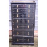 A late Victorian ebonised and gilt detailed chest of seven graduated long drawers, drawer stamped