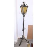 A 20th century wrought iron lamp, in the form of a Victorian street lamp, 62" high