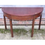 A mahogany semicircular side table, on chamfered supports, 40" wide, and a three-tier folding cake