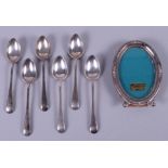 A set of six George V silver teaspoons, 2.8oz troy approx, and a silver oval photograph frame