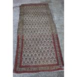 A Persian tribal rug with all-over "carnation" design on a light ground, 44" x 92" approx