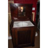 A 19th century mahogany washstand with lift up lid and enclosed two doors, 29" wide