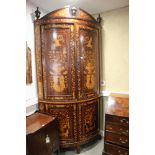 A Dutch marquetry bowfront corner cupboard with classical figures, vases of flowers, enclosed four
