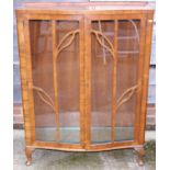 A 1950s walnut bowfront display cabinet, on cabriole supports, 34" wide