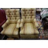 A pair of armchairs, button upholstered in an old gold striped fabric, on turned and castored