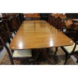 A George III design mahogany triple pillar dining table with two leaves, on reeded quadraform splay