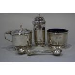 An Art Deco design silver three-piece cruet set, 3oz troy approx, and two silver plated condiment