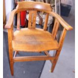 An Arts & Crafts oak panel seat armchair, on square tapered supports